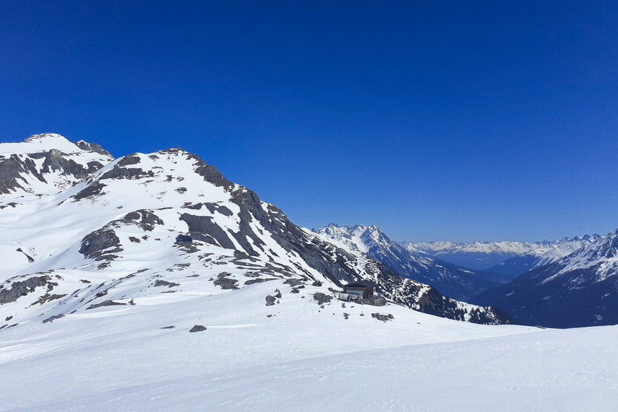 Quasi die Gegenperspektive des vorangegangenen Fotos für diejenigen, die die Tour noch verlängern möchten. Im Vordergrund eine private Hütte am Almajurjoch, der schwarze Fleck in der Verlängerung des Kamms die Leutkircher Hütte; über dieser der Hirschpleiskopf, der entweder sehr steil über die Westseite - oder in der Regel günstiger - über die Mulde links davon erstiegen werden kann. Die Mulde stellt auch den Zugang zum Stanskogel dar (ganz links im Bild). Foto: Florian Kreß