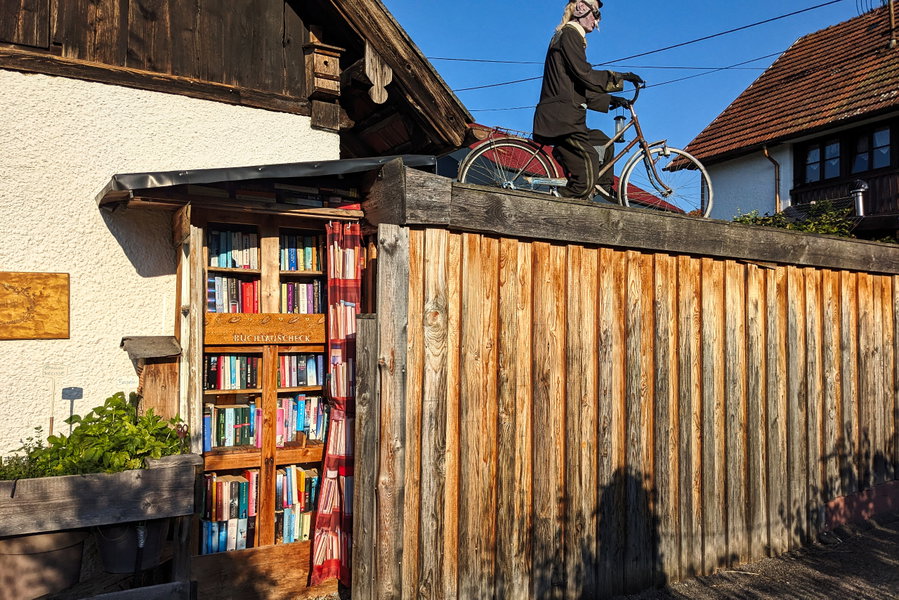Ein Radlfahrer, der im Dunkeln auch als Halloween-Dekoration durchgehen kann. In Wahrheit ist er Teil eines liebevoll gestalteten Gartens, sogar nach außen hin mit freier Bibliothek! Foto: Thomas Obermair